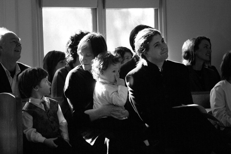 A family in a church watching a wedding.